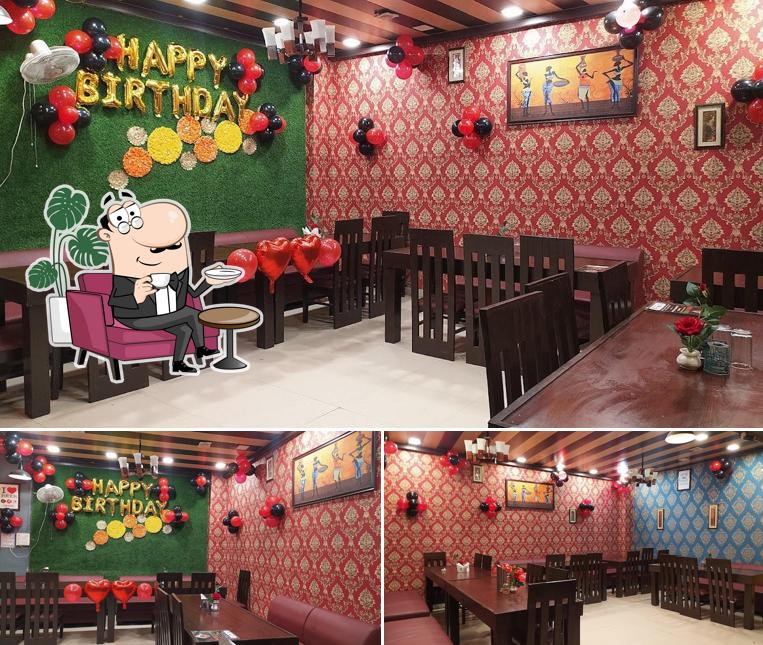 Take a seat at one of the tables at Urban Mirchi Restaurant And Cafe
