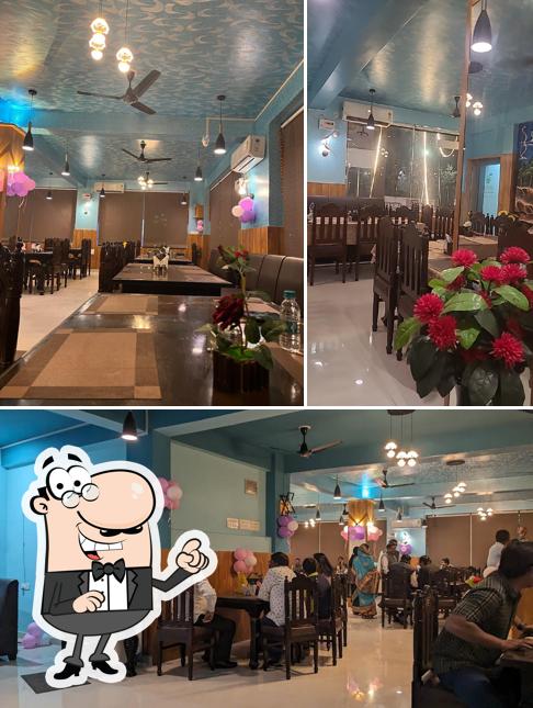 Take a seat at one of the tables at Aaharam Pure Vegetarian Restaurant