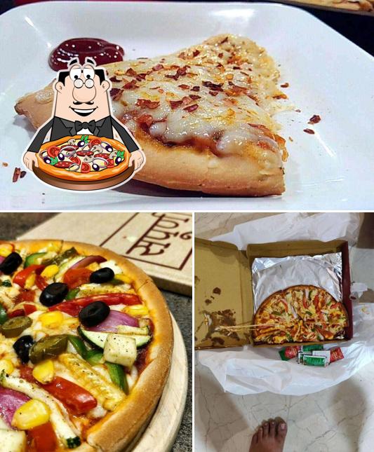 Get pizza at Sampoorna Gelateria & Pizzeria