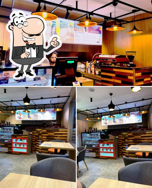 Take a seat at one of the tables at Barista Coffee Nagaon