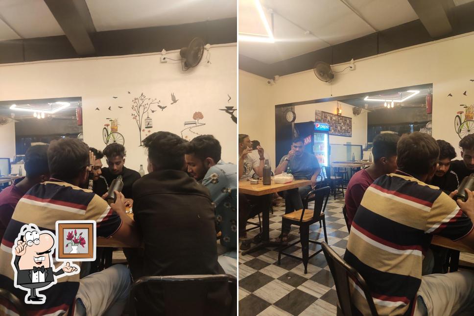 Take a seat at one of the tables at Mughal Cafe And Restaurant