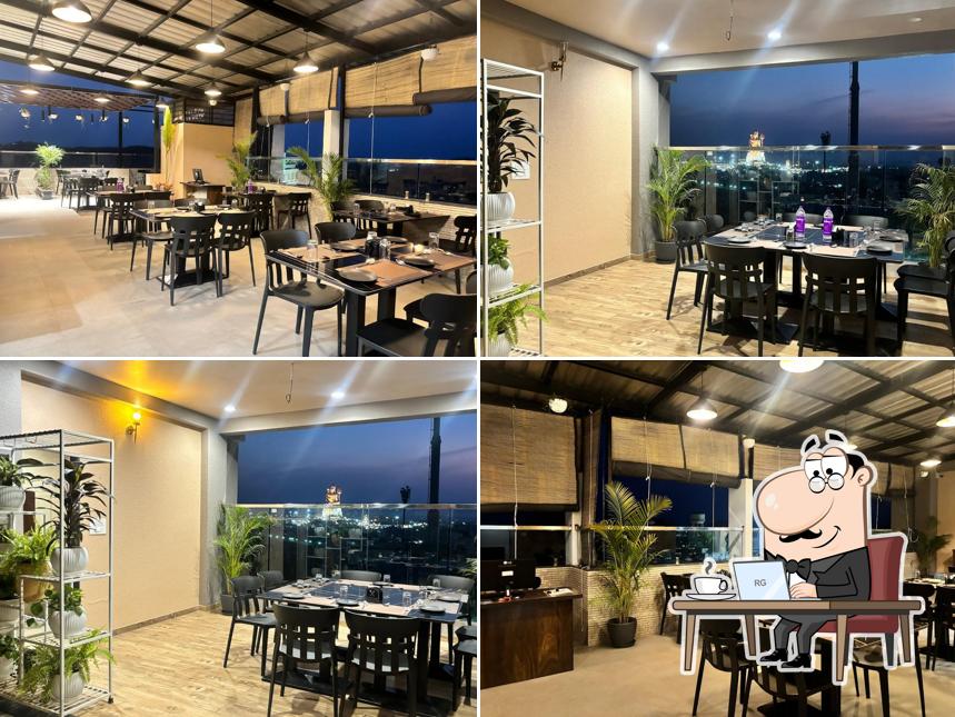 Take a seat at one of the tables at SAATVIK (सात्विक) - A Multi Cuisine Rooftop by MGH Best restaurant in Nathdwara