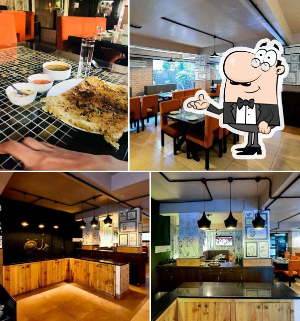 Take a seat at one of the tables at Swaad Desi by Firewood (Chaat & Chai Co.)