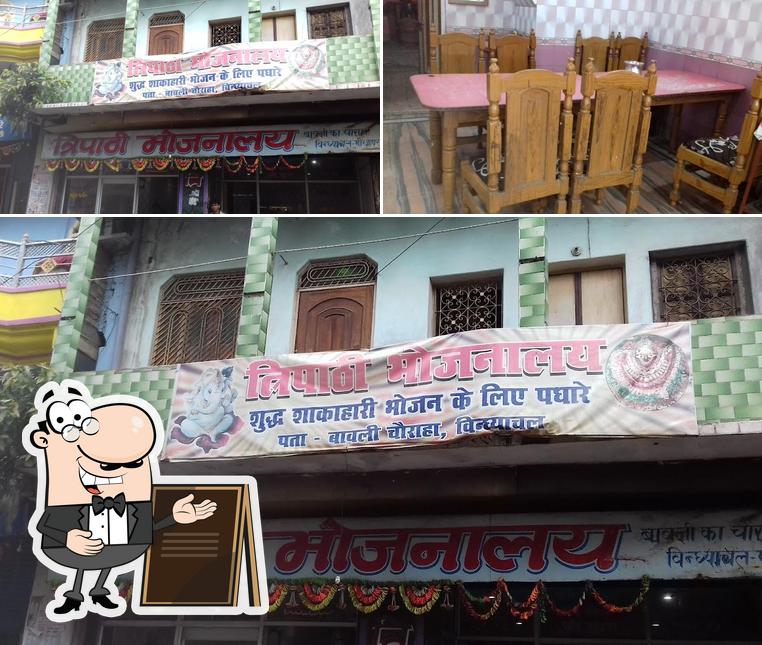 This is the image displaying exterior and dining table at Tripathi Bhojanalay