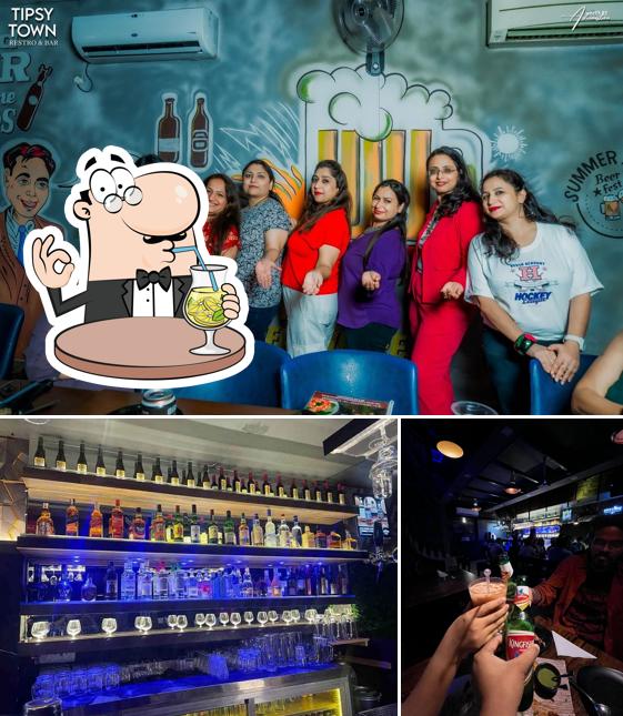 Check out the picture displaying drink and interior at Tipsy Town