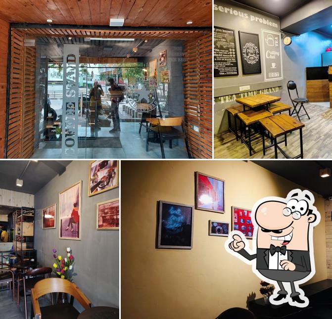 Take a seat at one of the tables at COFFEE STAND -CG Road