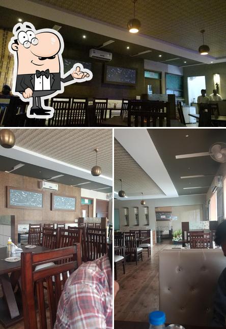 Take a seat at one of the tables at Highway halt restaurent and banquet hall - Best Banquet Hall, Kitty Hall, Restaurant