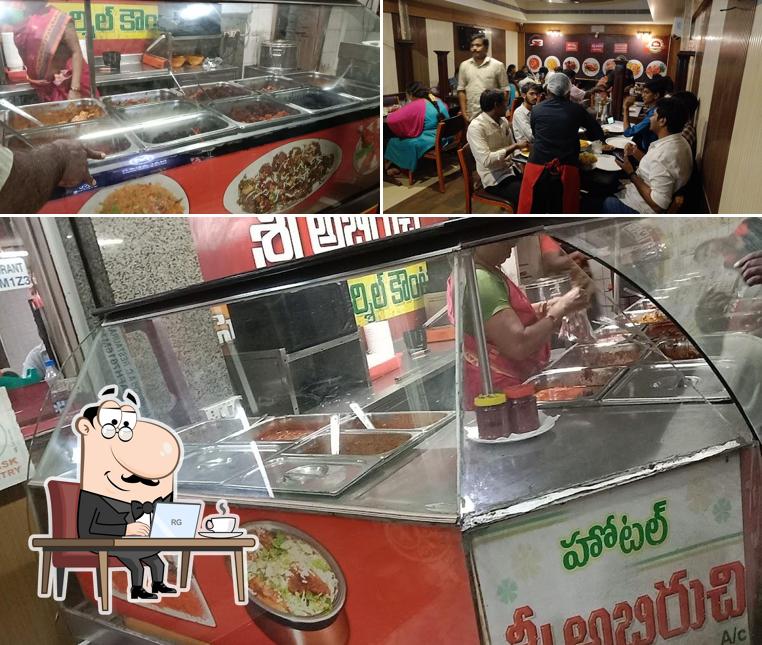 Take a seat at one of the tables at Abhiruchi Restaurant