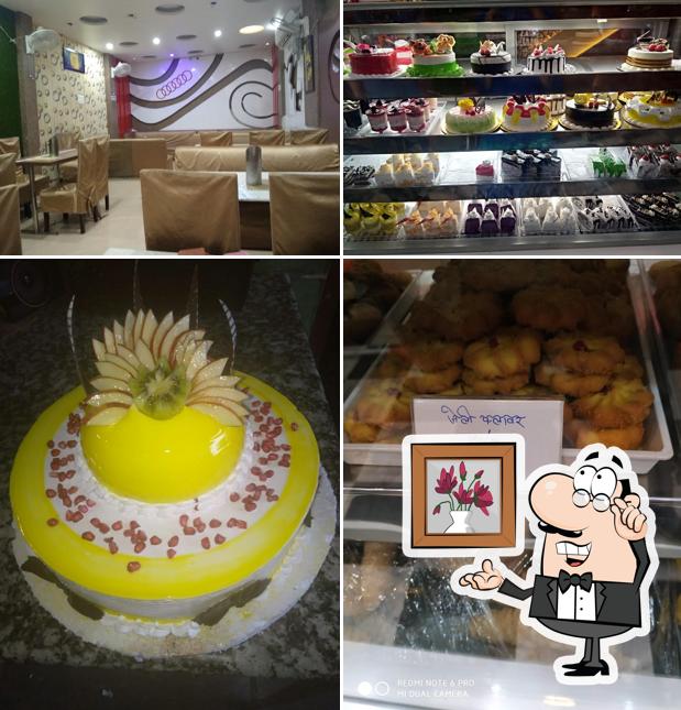 Take a seat at one of the tables at New Shivam Bakers & Restaurant