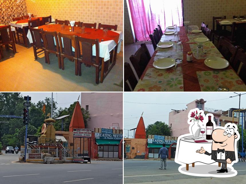 This is the image showing dining table and exterior at Eating Meeting Restaurant