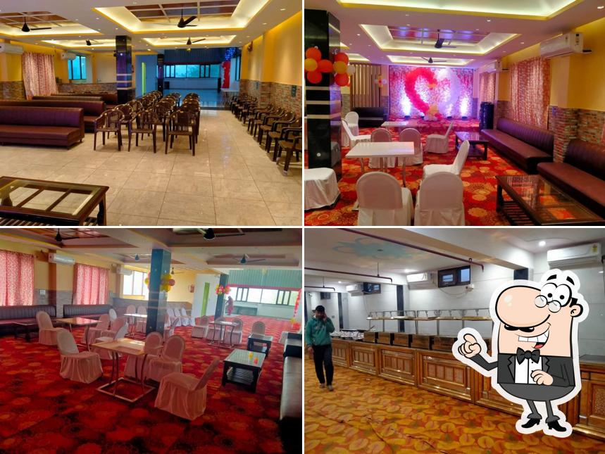 Take a seat at one of the tables at LAL KESAR HOTEL & RESTAURANT