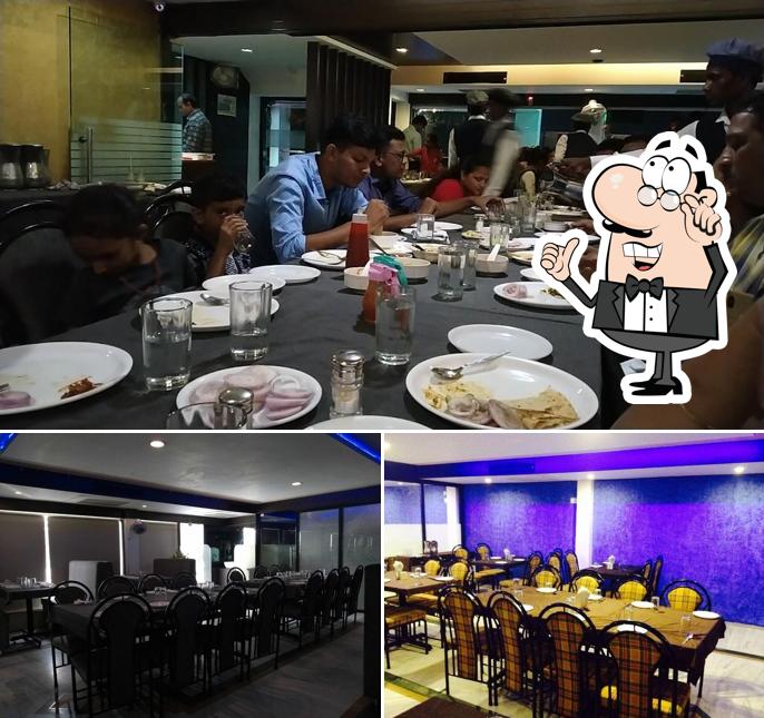 Take a seat at one of the tables at Surbhi Restaurant(CTM)