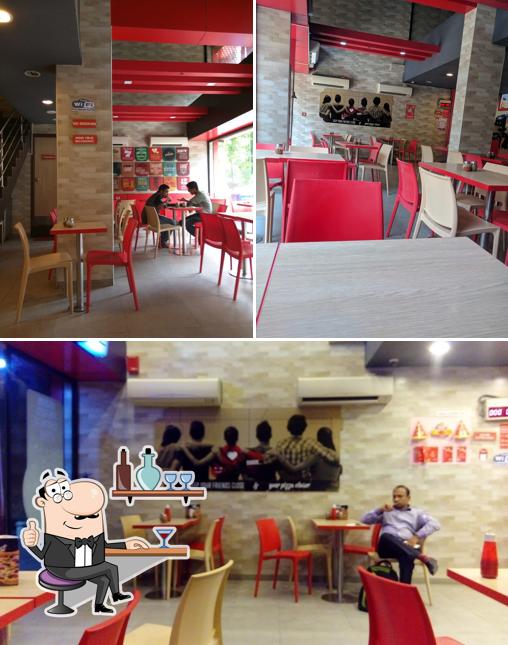 Take a seat at one of the tables at Pizza Hut Laxmi Nagar, Nagpur