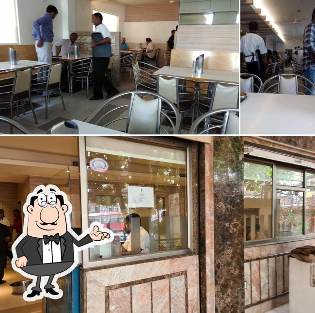 Take a seat at one of the tables at Hotel Sweekar - Veg Restaurant