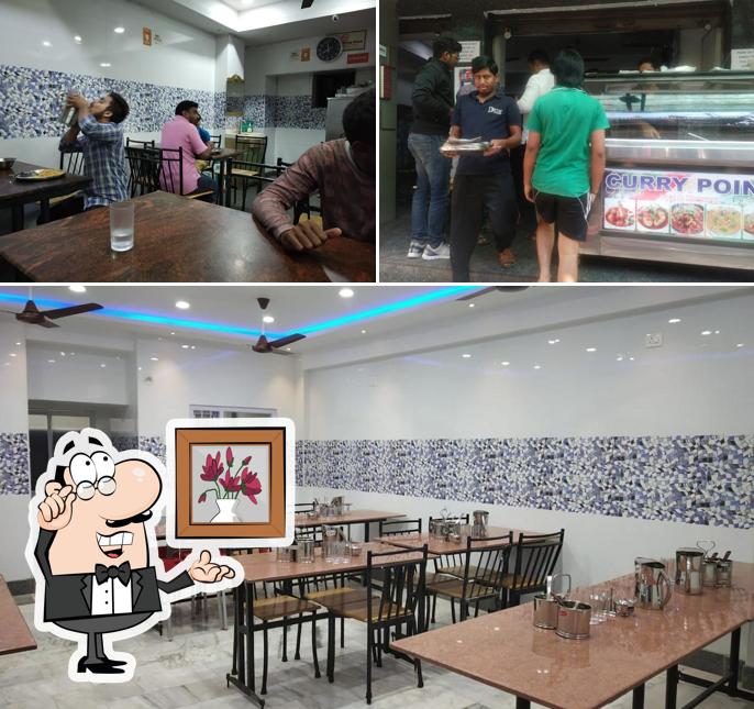 Take a seat at one of the tables at Indira Darshini(Top In Cafe)
