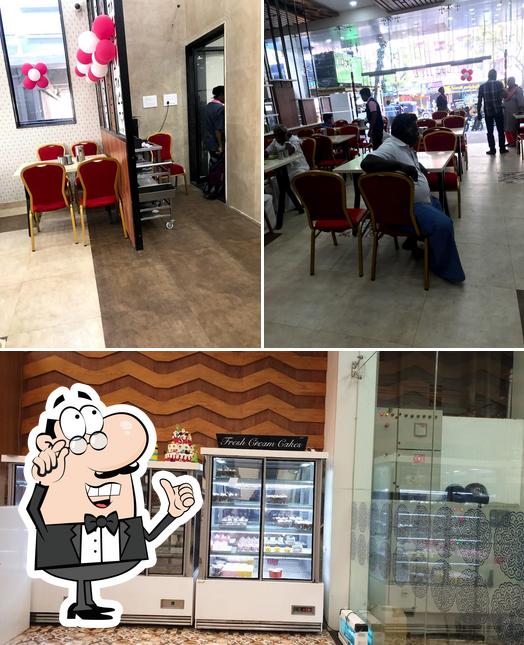 Take a seat at one of the tables at Aswins Veg Restaurant Aswins Sweets & Snacks