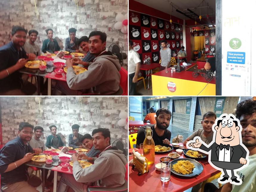 Take a seat at one of the tables at Bol Biryani, बोल बिरयानी