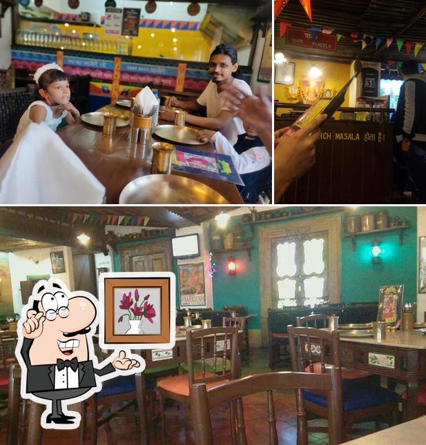 Take a seat at one of the tables at Mirch Masala, Maninagar