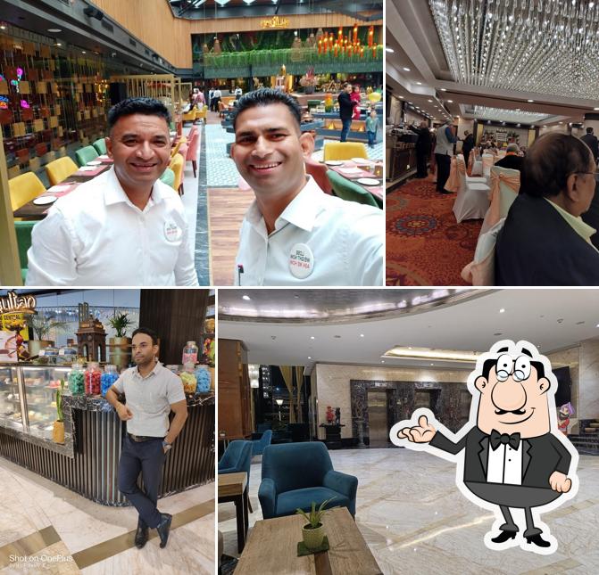 Take a seat at one of the tables at Lust By The Pool - Radisson Blu Kaushmabi Delhi NCR