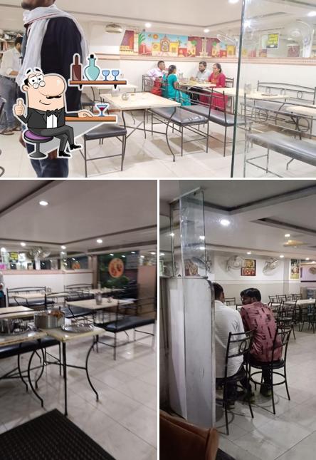 Take a seat at one of the tables at Shree Siddhivinayak Thali Restaurant