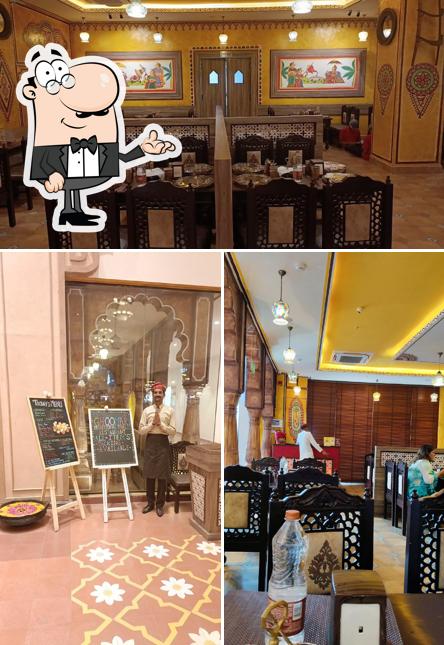 Take a seat at one of the tables at Ghoomar Traditional Thali Restaurants - Omaxe Chowk, Chandni Chowk