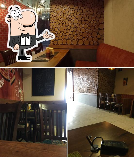 Take a seat at one of the tables at Enjoy Pizza Plus