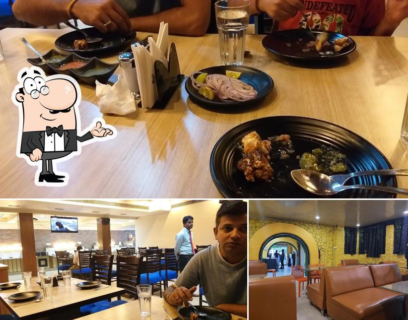 Take a seat at one of the tables at Naushijaan Restaurant - Large Range Of Awadhi Kebab