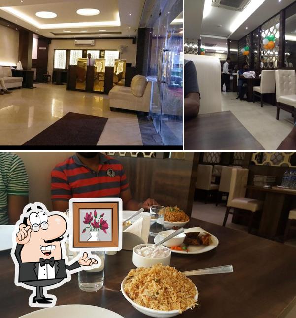 Take a seat at one of the tables at Buhari Hotel Mogappair West with Party hall