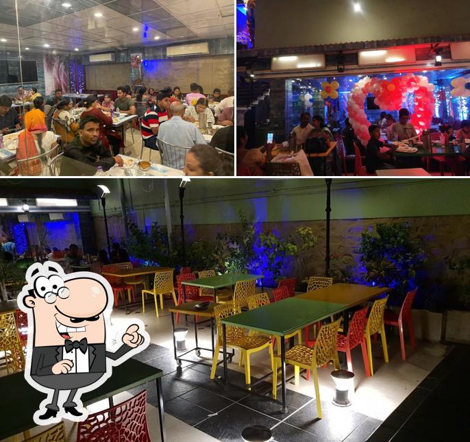 Take a seat at one of the tables at Ajinkya AC Veg Restaurant and Lodging