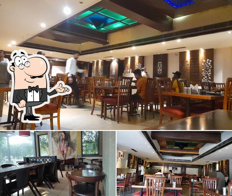 Take a seat at one of the tables at Mirchi Hotel & Restaurant
