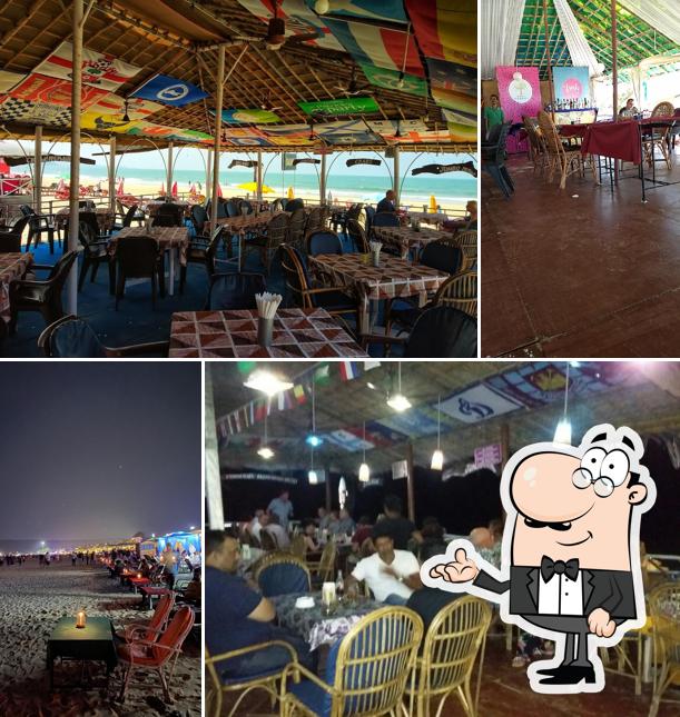 Take a seat at one of the tables at Sam's Beach Shack GOA