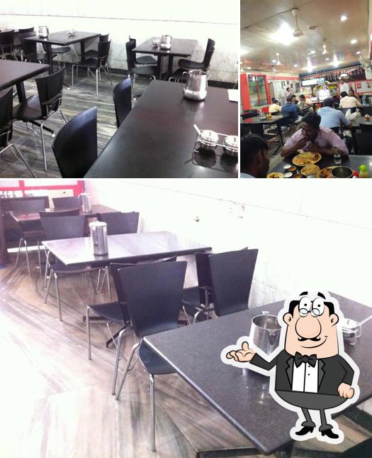 Take a seat at one of the tables at Hotel New Mugals (Veg, Non-Veg) Restaurant