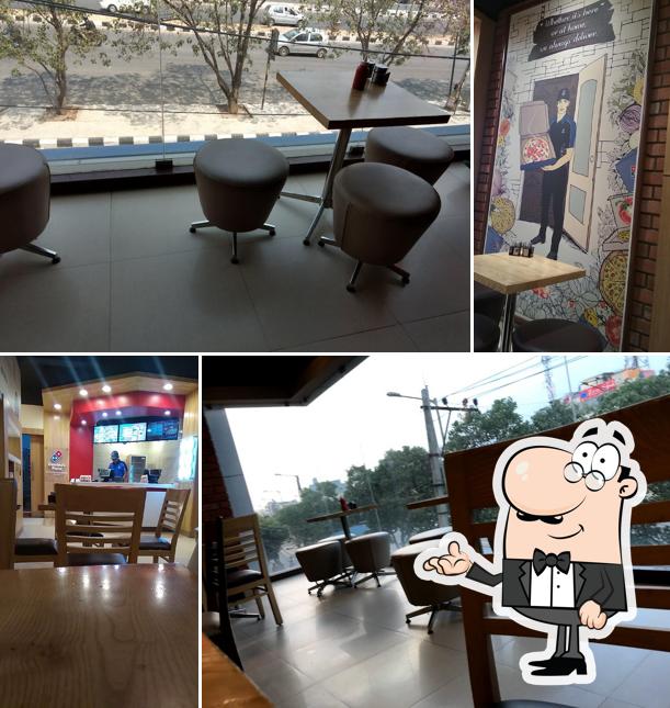 Take a seat at one of the tables at Domino's Pizza Marathalli, Bengaluru