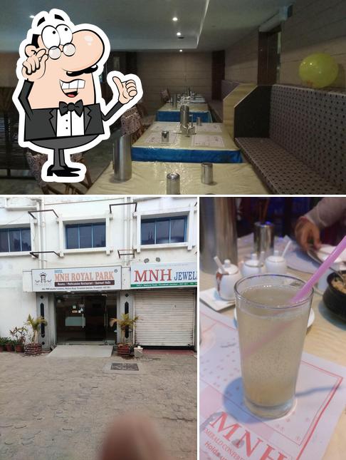 Take a look at the image showing interior and beverage at MH Family Restaurant