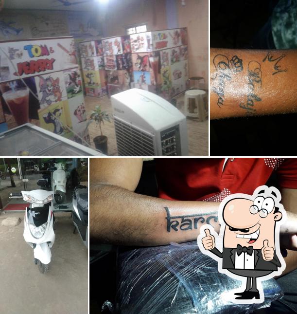 Look at the image of Tom And Jerry tattoo studio