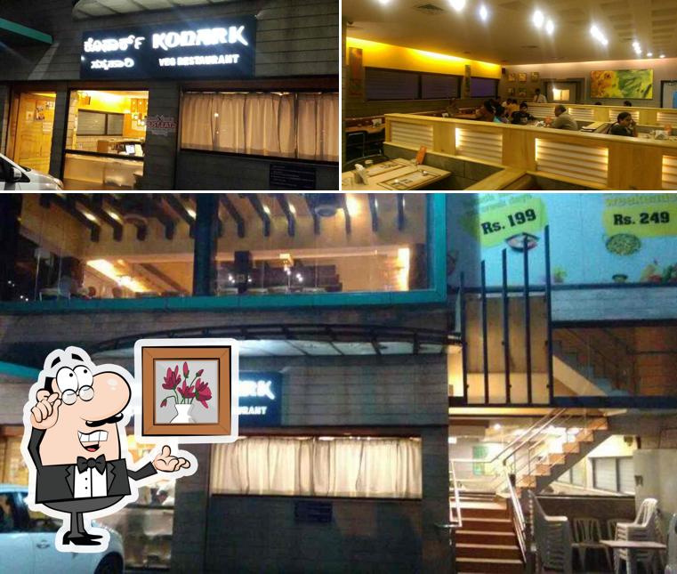 Take a seat at one of the tables at Konark Vegetarian Restaurant