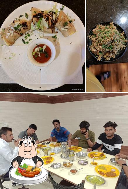 Take a look at the photo showing food and dining table at Panjabi Dhaba (NONVEG KING) Aapna Hindu Hotel