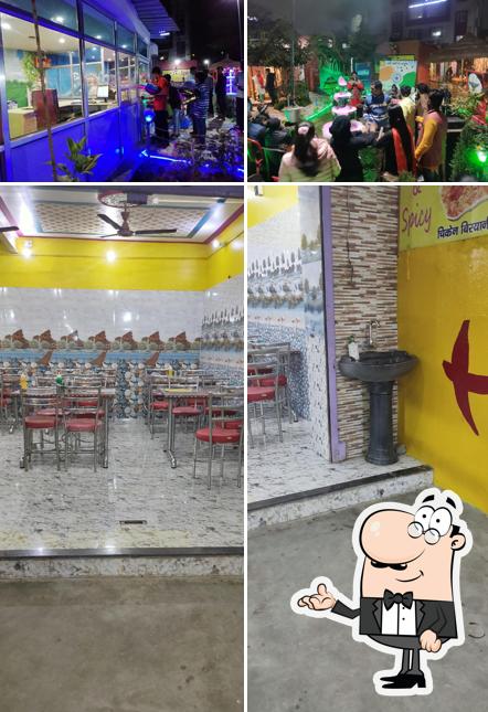 Take a seat at one of the tables at Hot & Spicy Family Food Hut