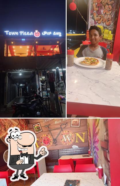 Take a look at the picture showing interior and dining table at Town Pizza Kota