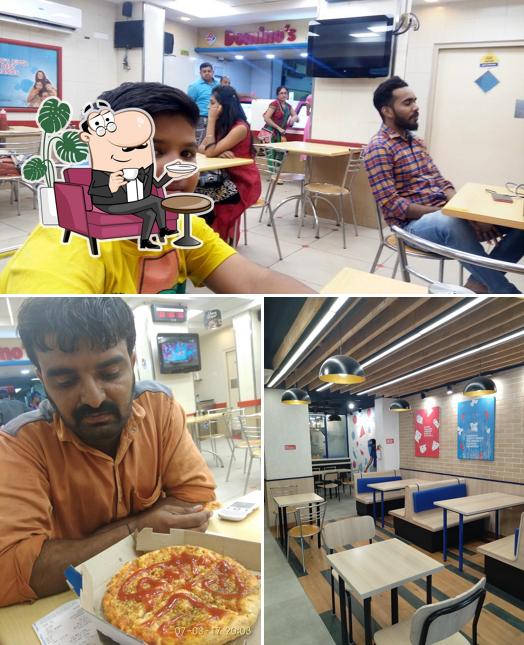 Take a seat at one of the tables at Domino's Pizza