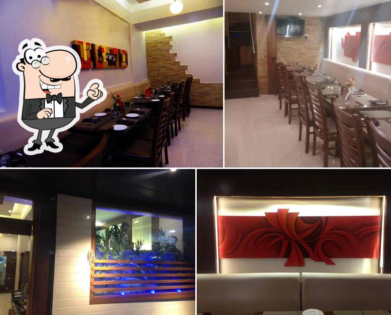 Take a seat at one of the tables at NEW GRAND FAMILY RESTAURANT & BAR