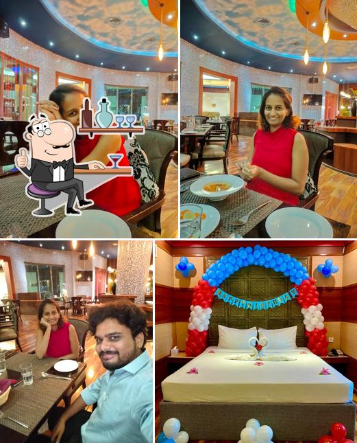 Take a seat at one of the tables at World In The Pot - Ramada Alleppey