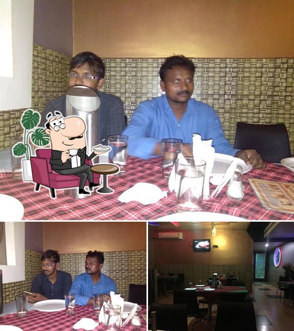 Take a seat at one of the tables at V. Srinivasa Grand Family Restaurant