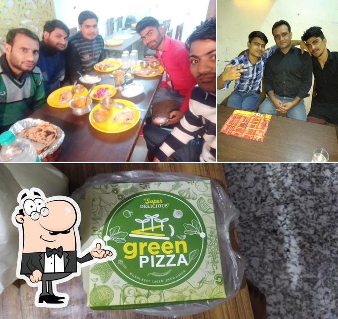 Take a look at the image displaying interior and food at Green Pizza
