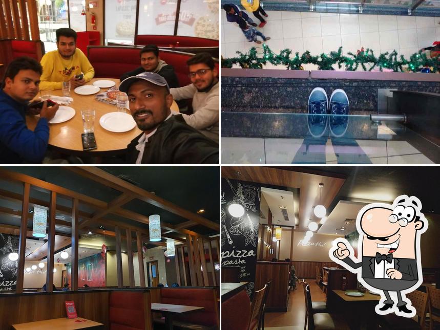 Take a seat at one of the tables at Pizza Hut Square Mall, Kanpur