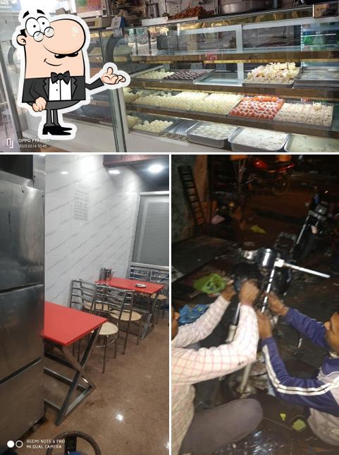 Take a seat at one of the tables at Shakti Sweets & Restaurant
