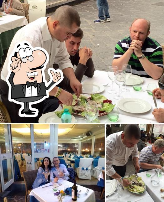 La foto della interni e tavolo da pranzo di Trattoria dal Tarantino