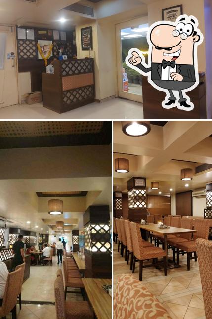 Take a seat at one of the tables at Shahji's Parantha House(Apte road)