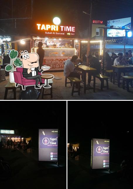 Take a seat at one of the tables at Tapri Time