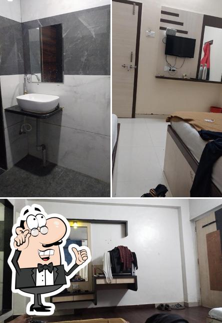 Take a seat at one of the tables at HOTEL BLUEBERRY BUDGET (Sai Dwarka)